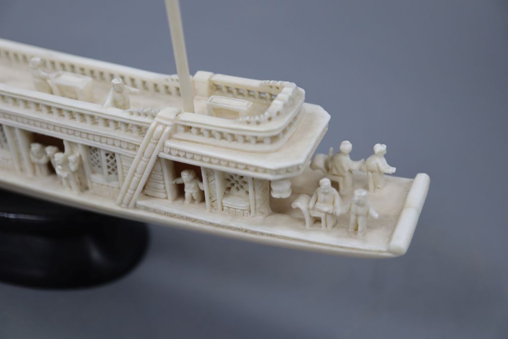 A Chinese carved ivory boat, on stand, length 23cm